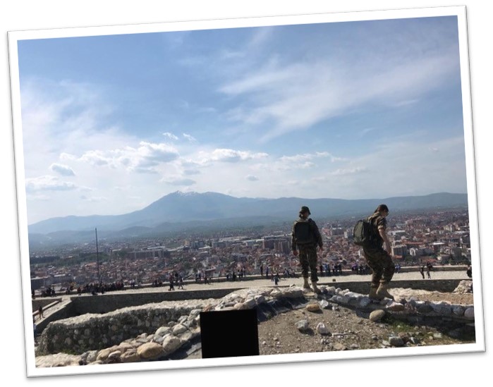 Two soldiers overlooking a city.